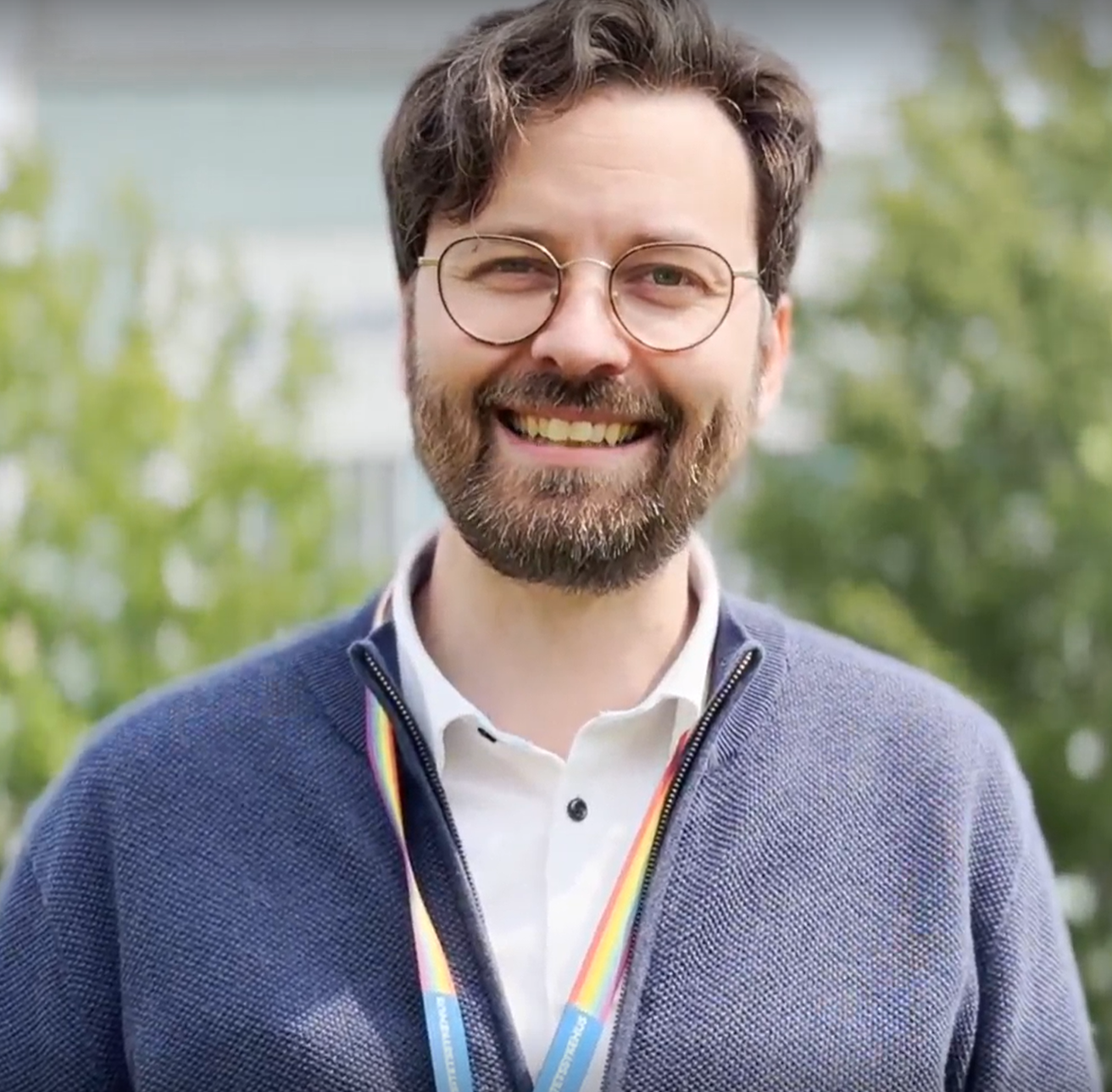 smilende mann med briller og skjegg