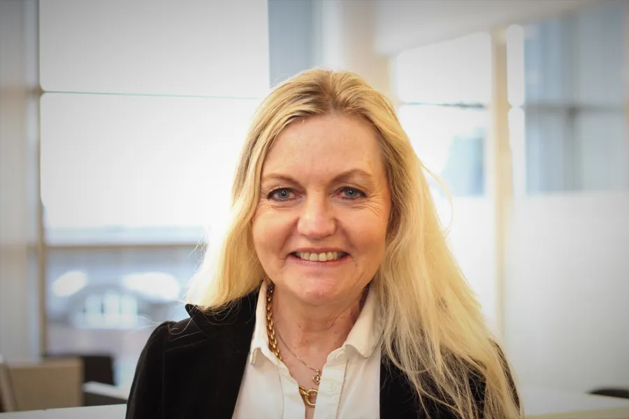 Smiling woman with blond hair. Photo.